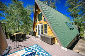 Wooden deck with french doors and a grill