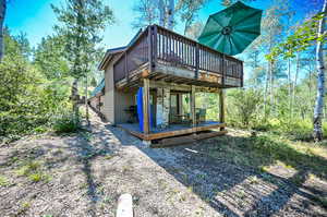 Rear view of house featuring a wooden deck