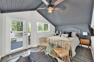 Bedroom with hardwood / wood-style floors, wood ceiling, access to exterior, lofted ceiling with beams, and ceiling fan