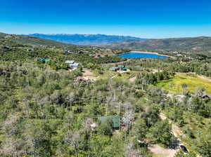 Drone / aerial view featuring a water and mountain view