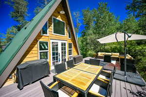 Wooden deck with area for grilling and an outdoor hangout area