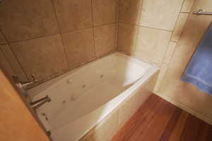 Bathroom featuring tiled bath and Jetted tub