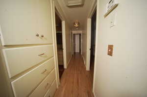 Hallway with hardwood / wood-style flooring