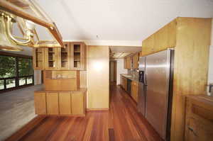 Kitchen with tasteful backsplash, a textured ceiling, sink, dark wood-type flooring, and appliances with stainless steel finishes