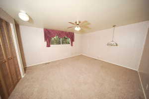 Master bedroom with a closet, ceiling fan, and carpet