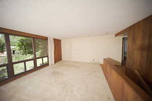 Interior space featuring wooden walls and a textured ceiling