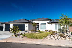 Prairie-style house with a garage and a front yard