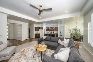 Living room featuring ceiling fan and wood-type flooring