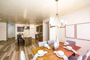 Dining area with an inviting chandelier and light wood-type flooring