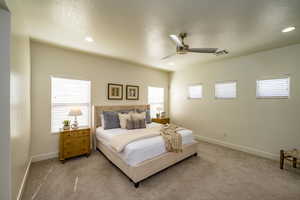 Bedroom featuring ceiling fan and carpet flooring