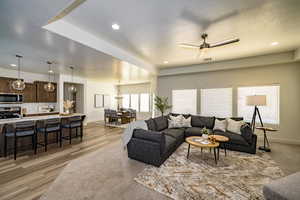 Living room featuring light hardwood / wood-style flooring and ceiling fan