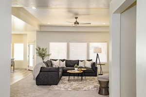 Living room with hardwood / wood-style floors and ceiling fan