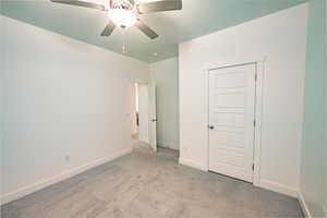 Unfurnished bedroom with a closet, ceiling fan, and light colored carpet