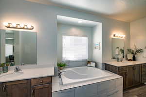 Bathroom with tiled bath and vanity