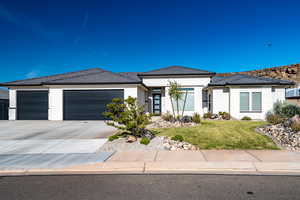 Prairie-style home with a garage and a front yard