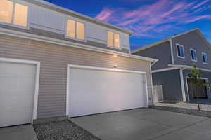 Property exterior at dusk featuring a garage