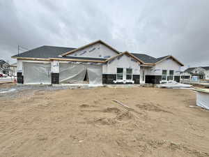 Unfinished property featuring a garage