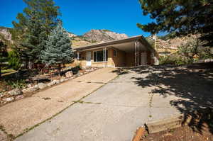 View of front facade with a garage and a mountain view