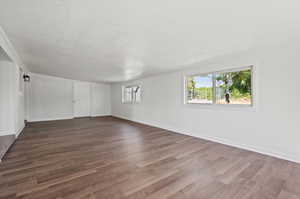 Empty room featuring dark hardwood / wood-style floors