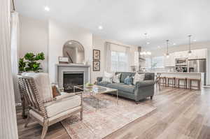 Living room featuring a notable chandelier and light hardwood / wood-style flooring