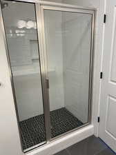 Master Bathroom with walk in shower and tile patterned floors