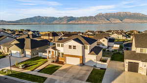 Birds eye view of property with a water and mountain view