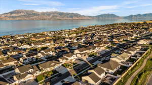 Birds eye view of property featuring a water and mountain view