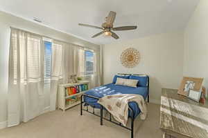 Bedroom featuring ceiling fan and light carpet