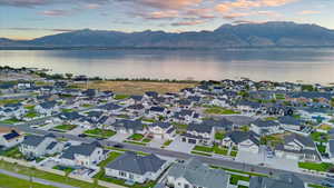 Aerial view at dusk featuring a water and mountain view