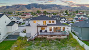 Back house at dusk with a balcony and a mountain view