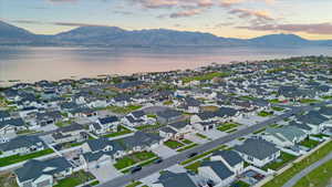 Aerial view at dusk featuring a water and mountain view