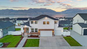 View of front of house featuring a garage and a water and mountain view