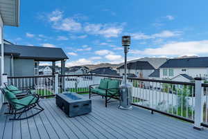 Wooden deck with an outdoor living space with a fire pit