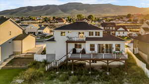 Rear view of property featuring a balcony and a mountain view