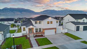 View of front of house featuring a garage and a water and mountain view