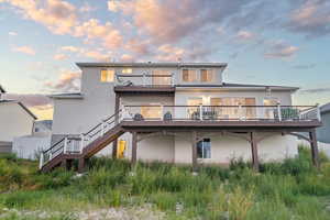 Back house at dusk with a deck