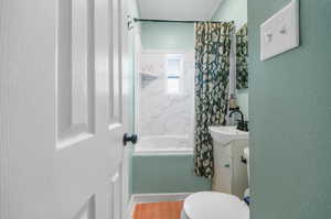 Full bathroom featuring vanity, toilet, shower / tub combo, and tile patterned floors