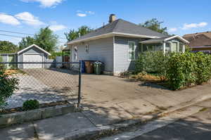 View of property exterior with an outdoor structure and a garage