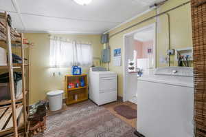 Laundry room with separate washer and dryer and electric panel