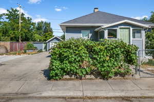 View of front of house with a garage and an outdoor structure