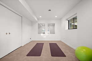 Exercise room featuring light colored carpet