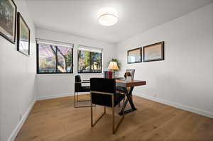 Office area with hardwood / wood-style flooring