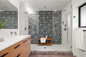 Bathroom with vanity and a shower with shower door