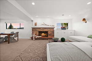 Bedroom with a fireplace and carpet