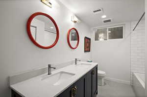 Full bathroom with vanity, toilet, shower / washtub combination, and tile patterned flooring