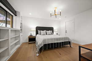 Bedroom featuring light hardwood / wood-style flooring and a chandelier