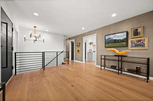 Interior space with light hardwood / wood-style flooring and a notable chandelier