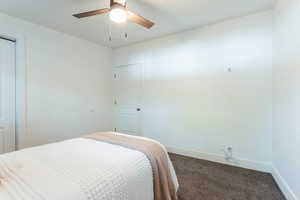 Carpeted bedroom featuring ceiling fan