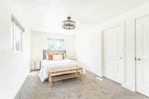 Bedroom featuring light colored carpet