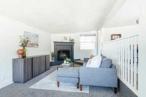 Living room with carpet floors and vaulted ceiling